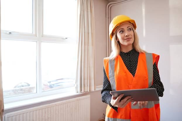 Female,Surveyor,In,Hard,Hat,And,High,Visibility,Jacket,With