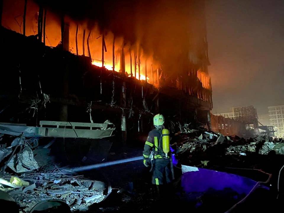 Rescuers work at a site of a shopping mall damaged by an airstrike in Kyiv