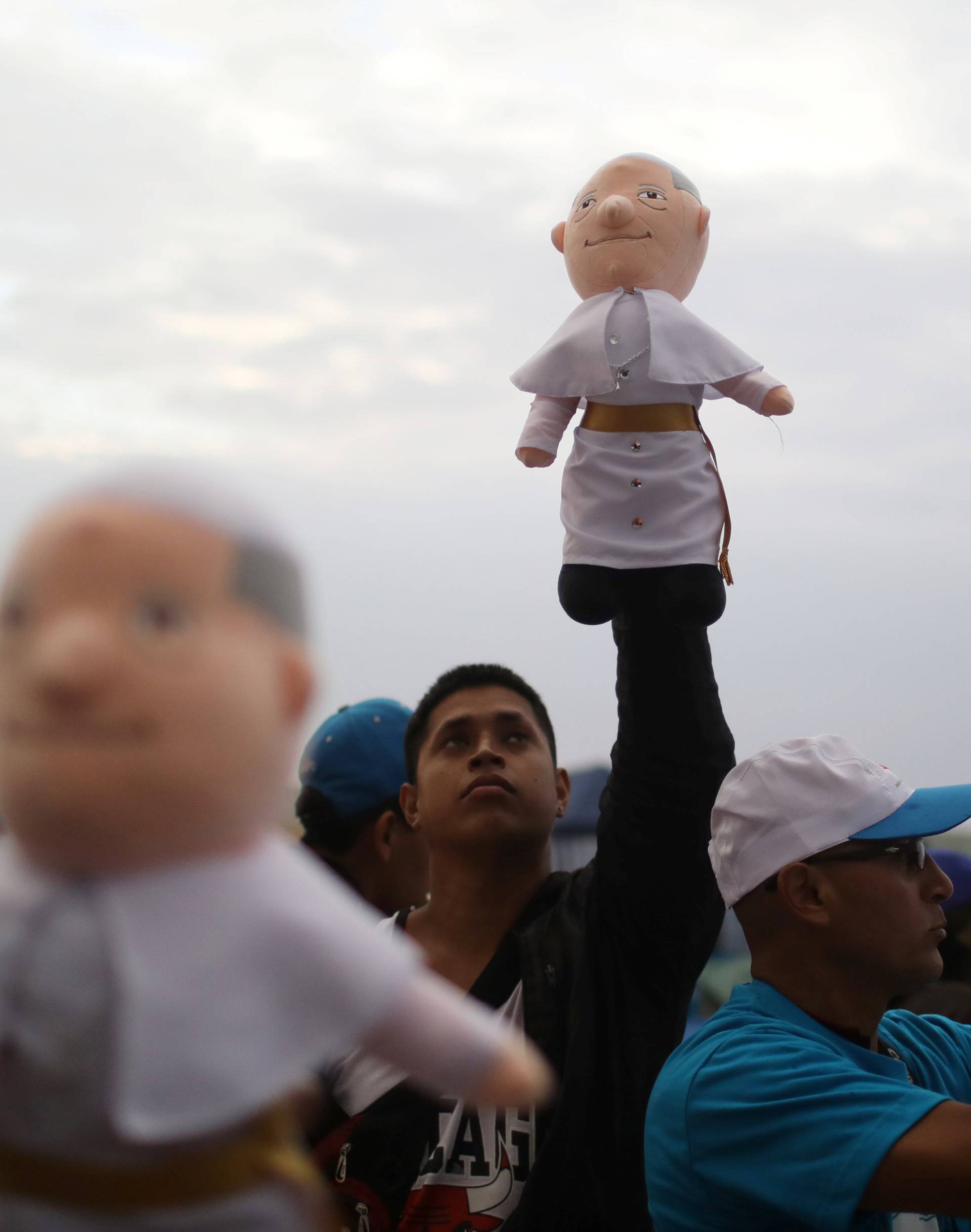 A man sells Pope Francis dolls at Huanchaco beach, where the Pope will hold a mass, in Trujillo, Peru