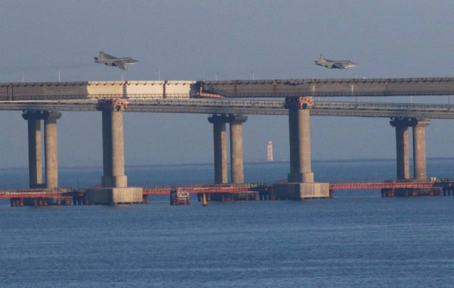 Russian jet fighters fly over a bridge connecting the Russian mainland with the Crimean Peninsula after three Ukrainian navy vessels were stopped by Russia from entering the Sea of Azov via the Kerch Strait in the Black Sea