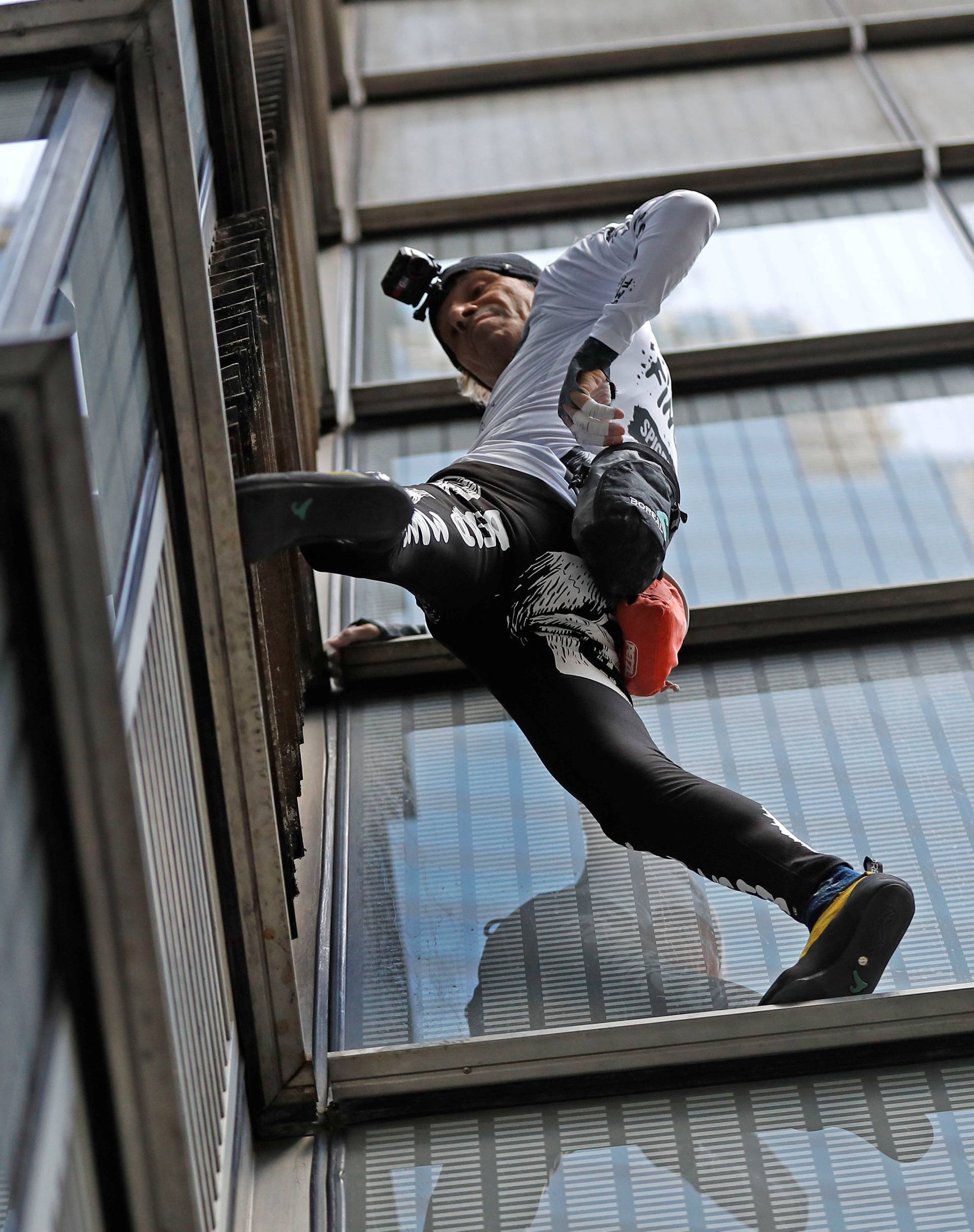 French free-climber Alain Robert, known as 'Spiderman', attempts to climb up the outside of the Heron Tower in the financial district of London