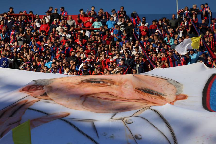 Fans of San Lorenzo de Almagro, Pope Francis' hometown soccer team, cheer for their team, in Buenos Aires