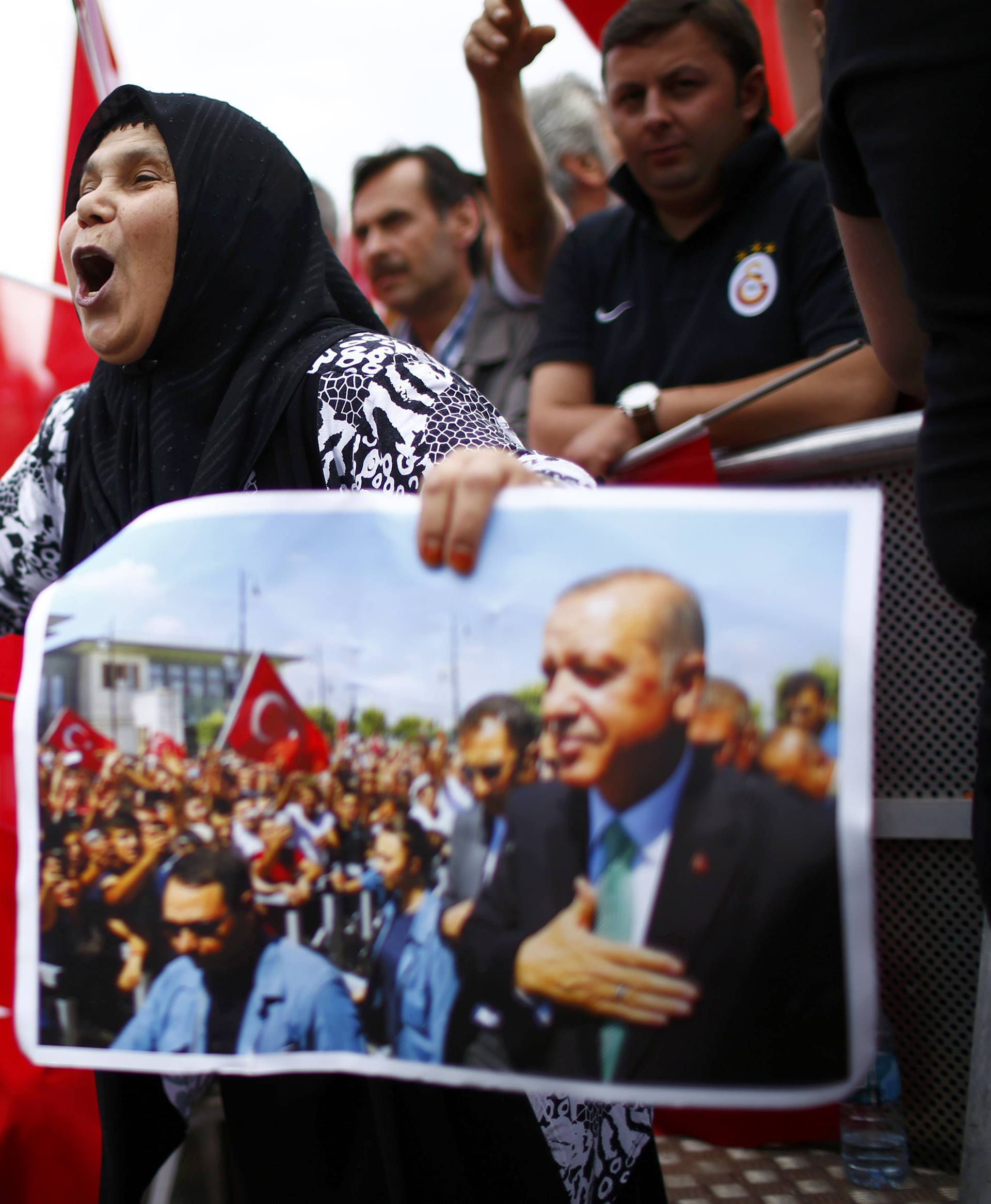 Supporters of Turkish President Erdogan wave Turkish flags during a pro-government protest in Cologne