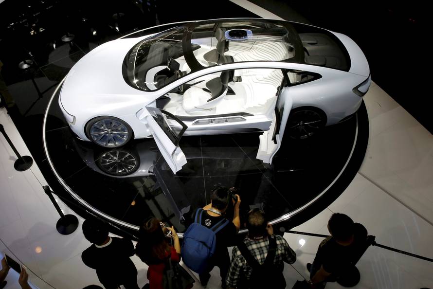 Visitors look at all-electric battery concept car called LeSEE during Auto China 2016 auto show in Beijing