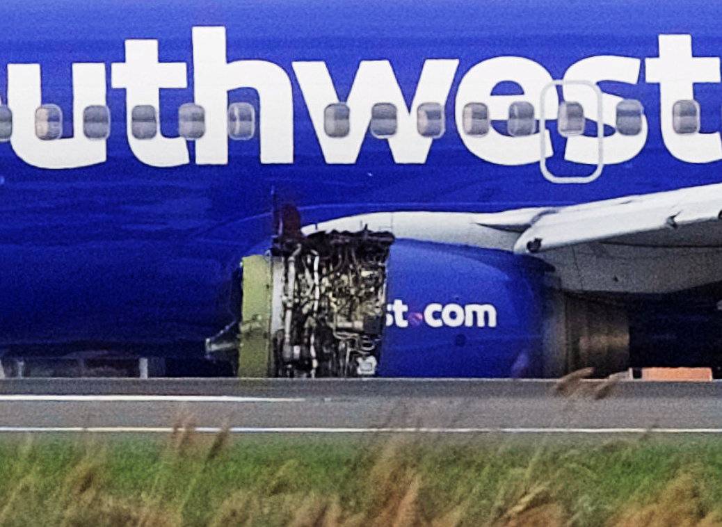 Emergency personnel monitor the damaged engine of Southwest Airlines Flight 1380, which diverted to the Philadelphia International Airport this morning, in Philadelphia, Pennsylvania