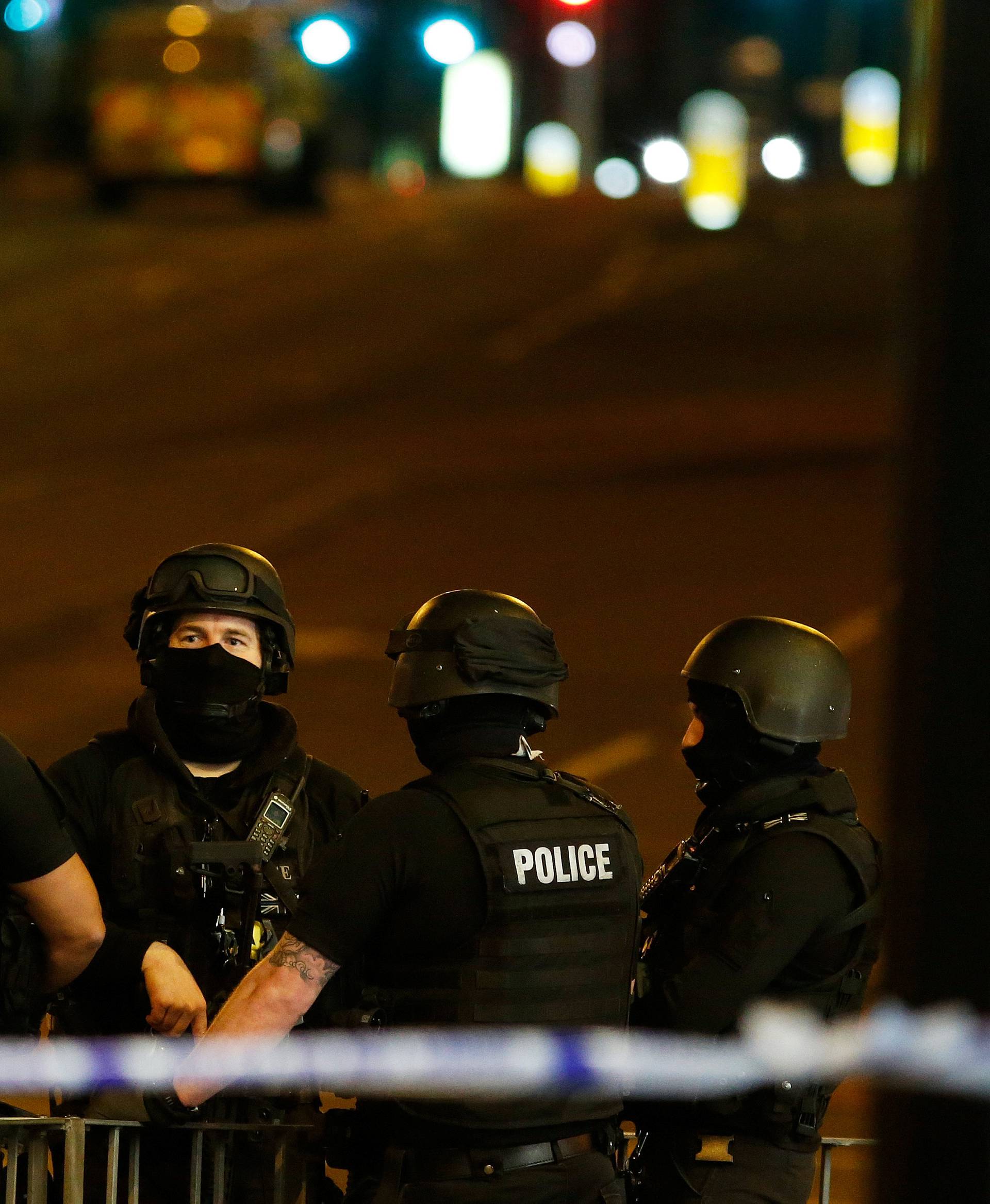 Armed police officers stand near the Manchester Arena, where U.S. singer Ariana Grande had been performing, in Manchester, northern England, Britain