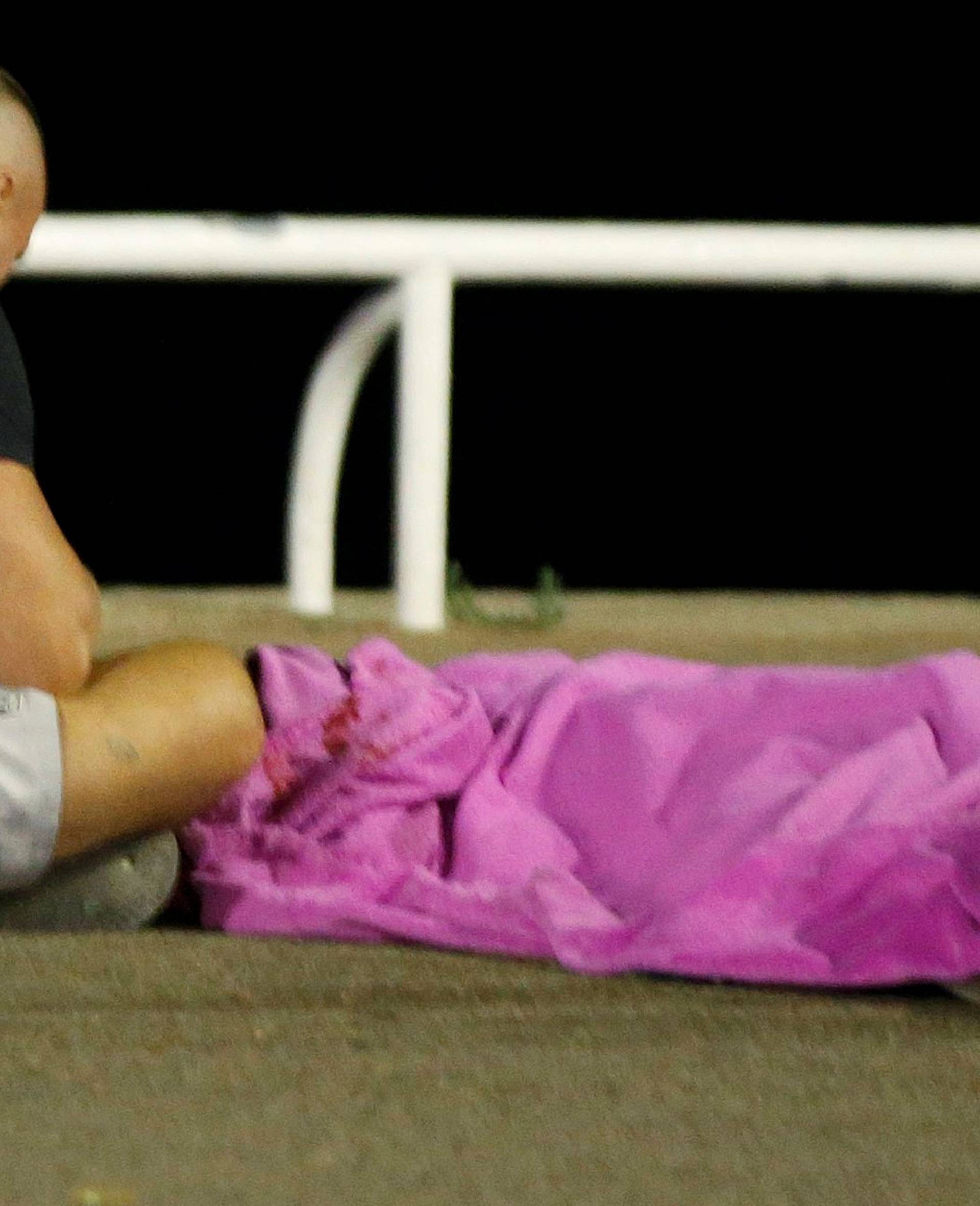 A body is seen on the ground after at least 30 people were killed in the southern French town of Nice when a truck ran into a crowd celebrating the Bastille Day national holiday