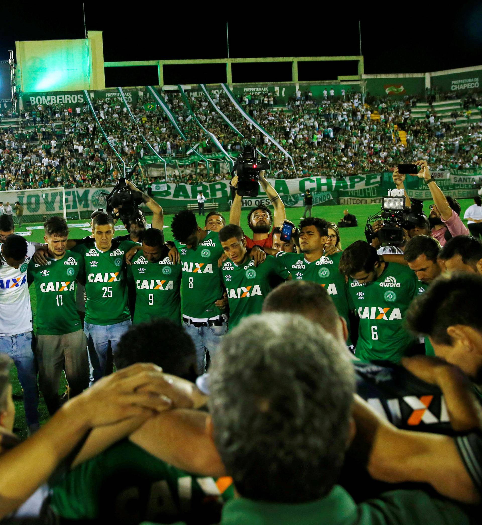 Players of Chapecoense soccer team that didn't travel to Colombia pay tribute to teammates with relatives at the Arena Conda stadium in Chapeco