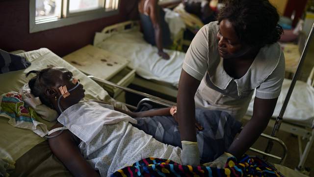 FILE PHOTO: Hawanatu Conteh, a nurse at Connaught Hospital, tends to a patient while the hospital's doctors strike over pay and conditions, in Freetown