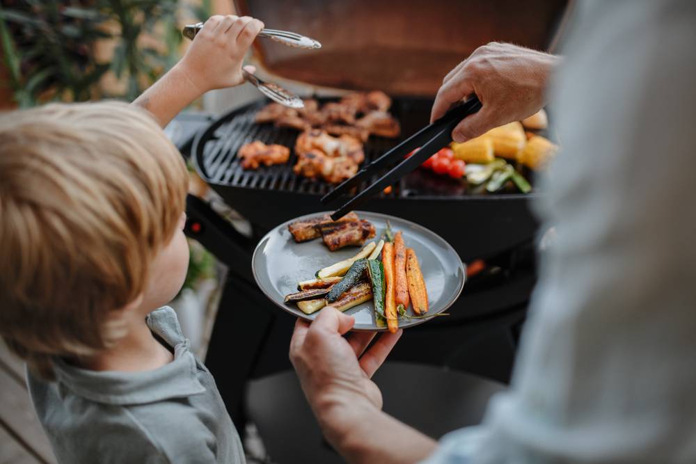 Unrecognizable,Father,With,Little,Son,Grilling,Ribs,And,Vegetable,On