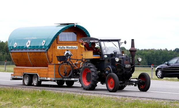 Soccer fan from Pforzheim, Germany, Wirth, 70, drives his tractor with a trailer to attend the FIFA 2018 World Cup in Russia, near the village of Yasen