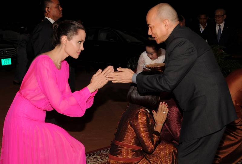 Actress Angelina Jolie greets King Norodom Sihamoni of Cambodia as she arrives for the opening ceremony of the film "First They Killed My Father" in Siem Reap