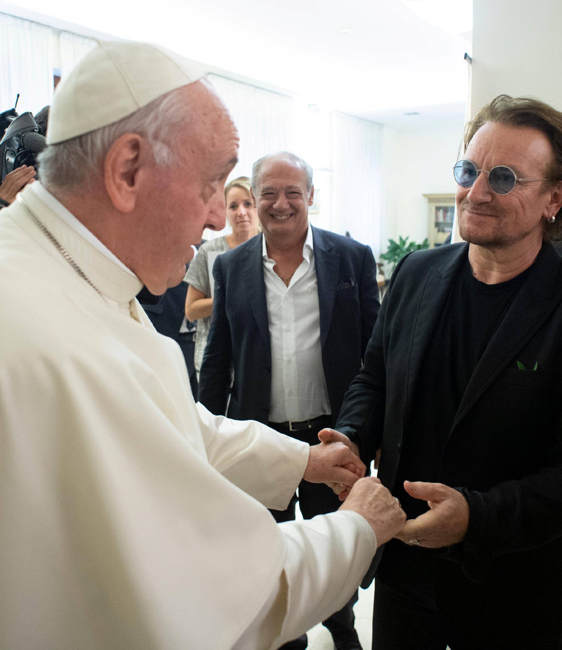 U2 rock band frontman Bono Vox meets Pope Francis at the Vatican