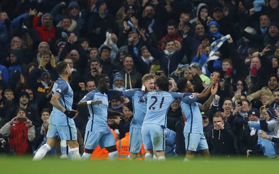 Manchester City's Raheem Sterling celebrates scoring their second goal with team mates