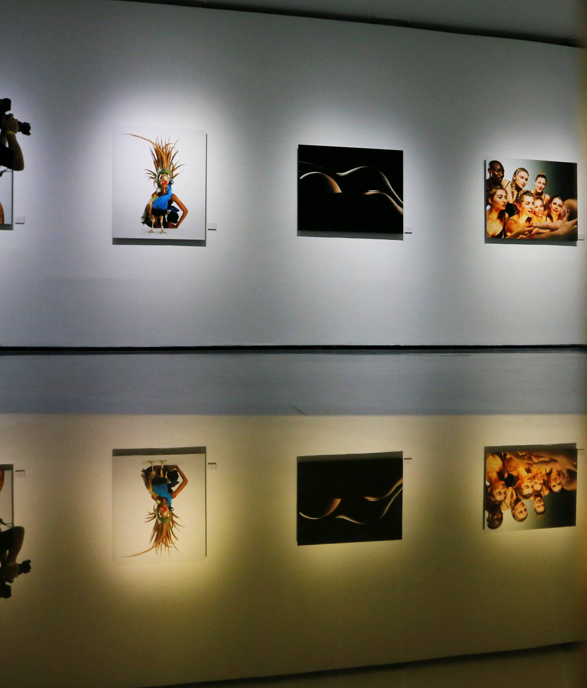 Photographer takes pictures during press presentation of photography project "Women in Gold" by Spanish actor and director Banderas in Moscow