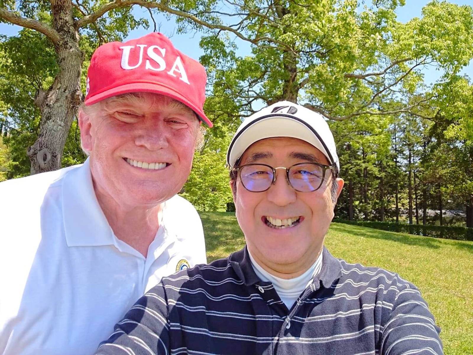 Japan's Prime Minister Shinzo Abe poses for a selfie with U.S. President Donald Trump at Mobara Country Club in Mobara