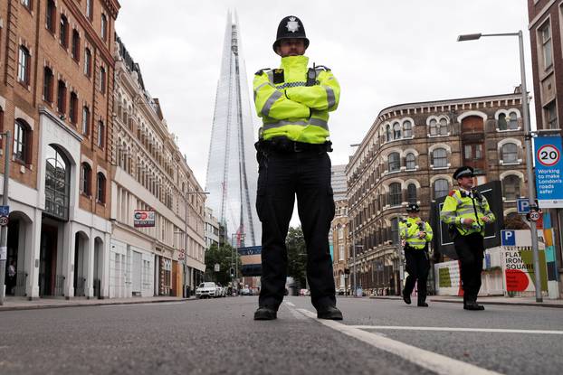 A police officer stands on a closed street near Borough Market after an attack left 7 dead and dozens of injured in central London