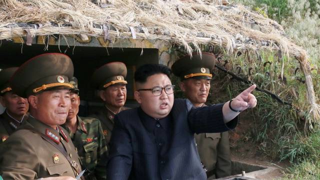 North Korean leader Kim Jong Un inspects the defence detachment on Jangjae Islet and the Hero Defence Detachment on Mu Islet located in the southernmost part of the waters off the southwest front, in this undated photo released by North Korea's KCNA