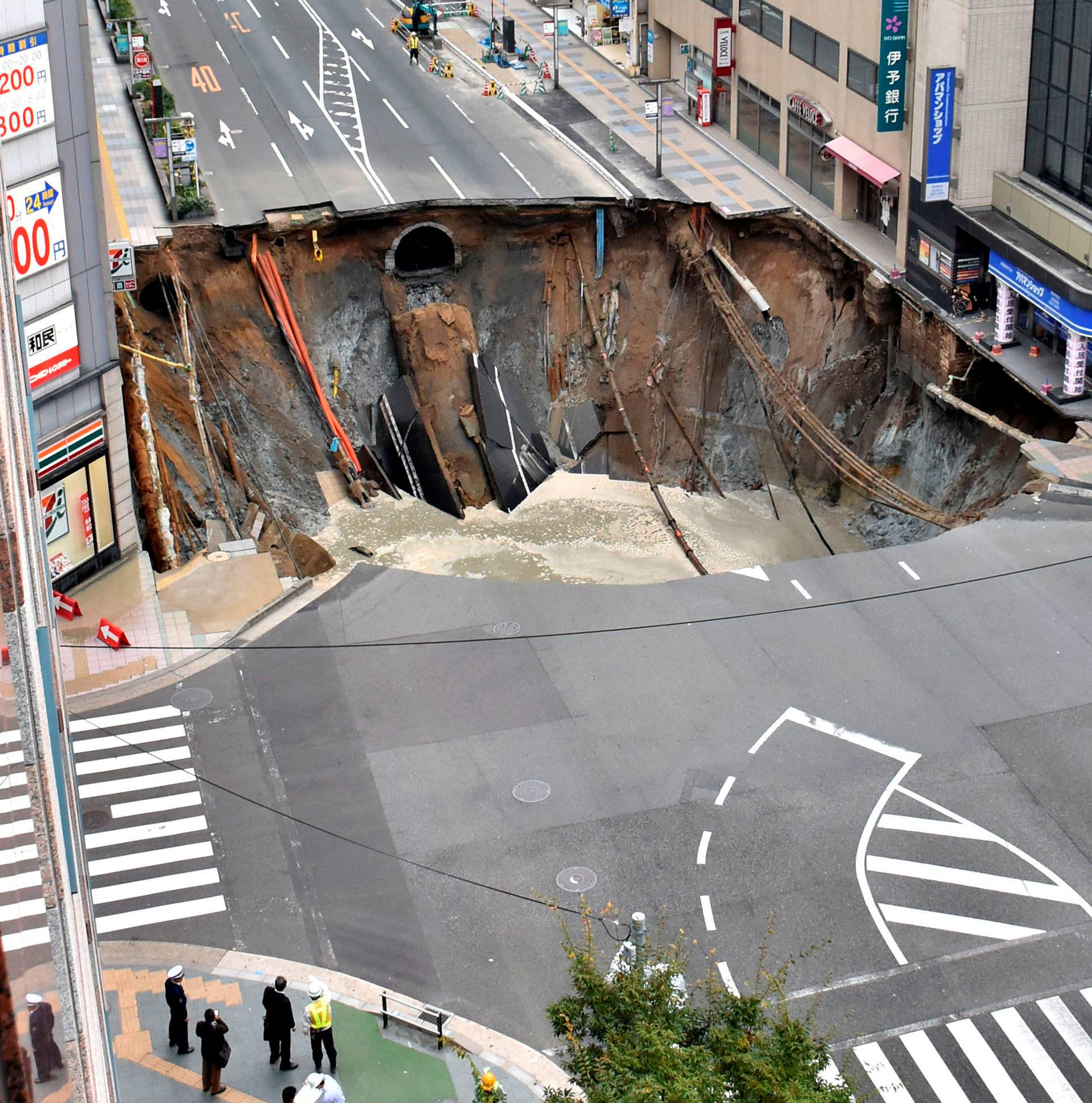 A huge sinkhole is seen at an intersection near Hakata station in Fukuoka