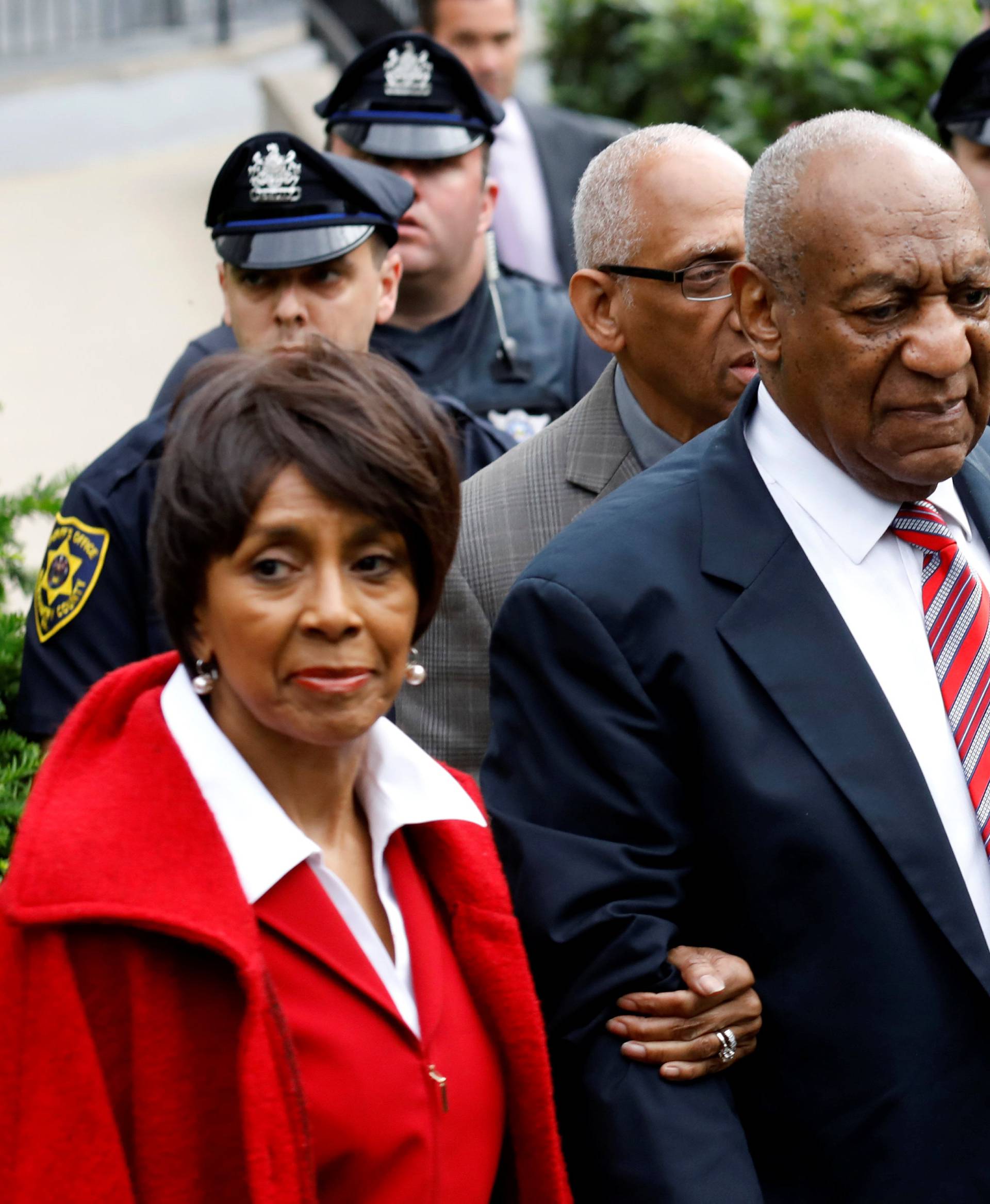 Actor and comedian Bill Cosby leaves with John Atchison and Sheila Frazier after the third day of Cosby's sexual assault trial at the Montgomery County Courthouse in Norristown