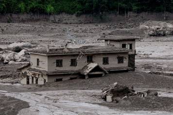 Mud covers a property following a flash flood at Trishuli, Nepal