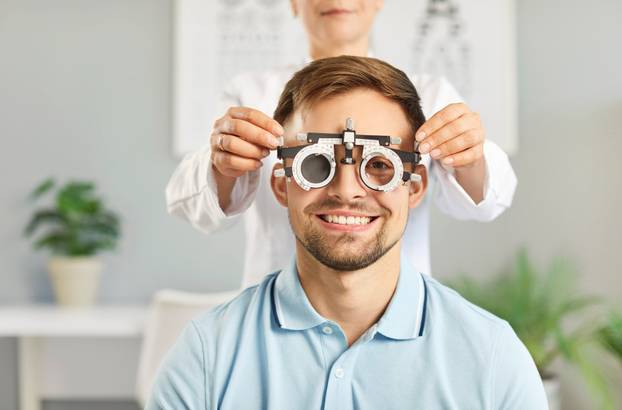 Happy,,Smiling,Male,Patient,Getting,Eye,Check,At,Optometrist's,Office.