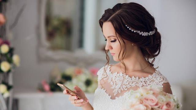 bride hold wedding bouquet of rose peonies and roses.