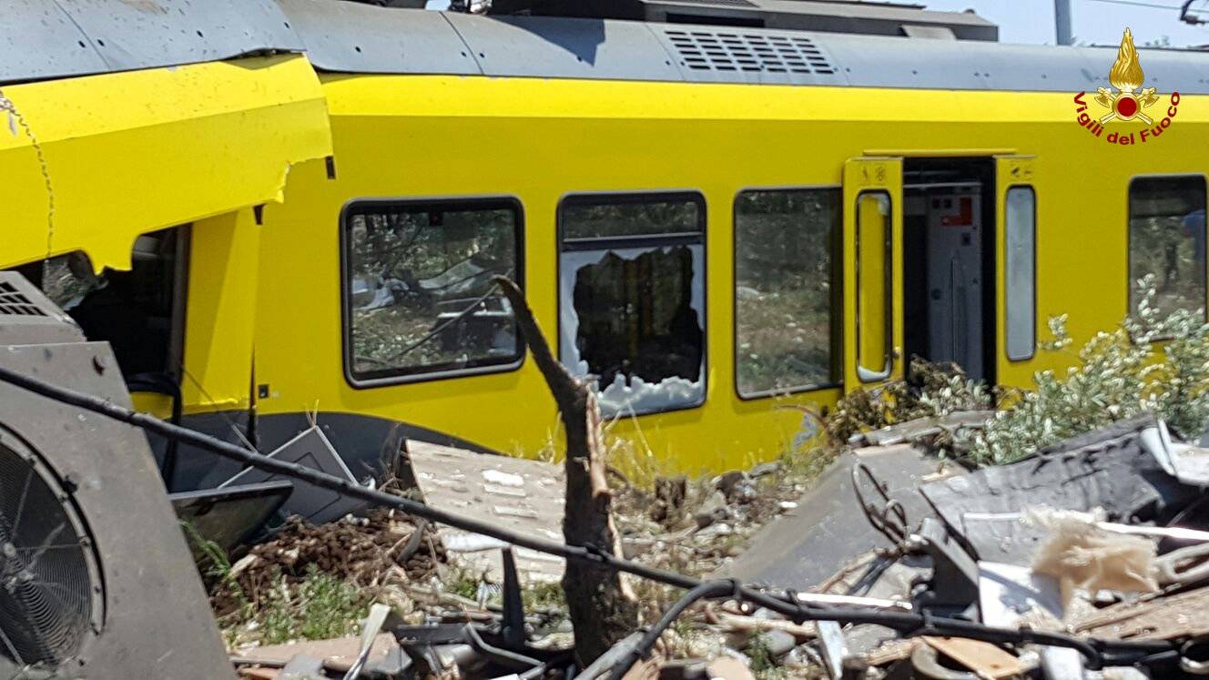 A damaged passenger train is seen after a collision with another in the middle of an olive grove in the southern village of Corato