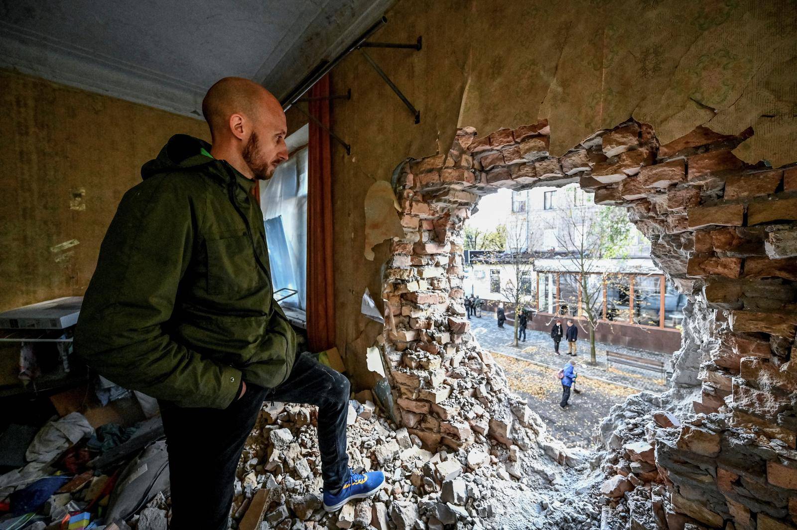 A local resident Dmytro stands in a flat in an apartment building destroyed by a Russian missile strike in Zaporizhzhia