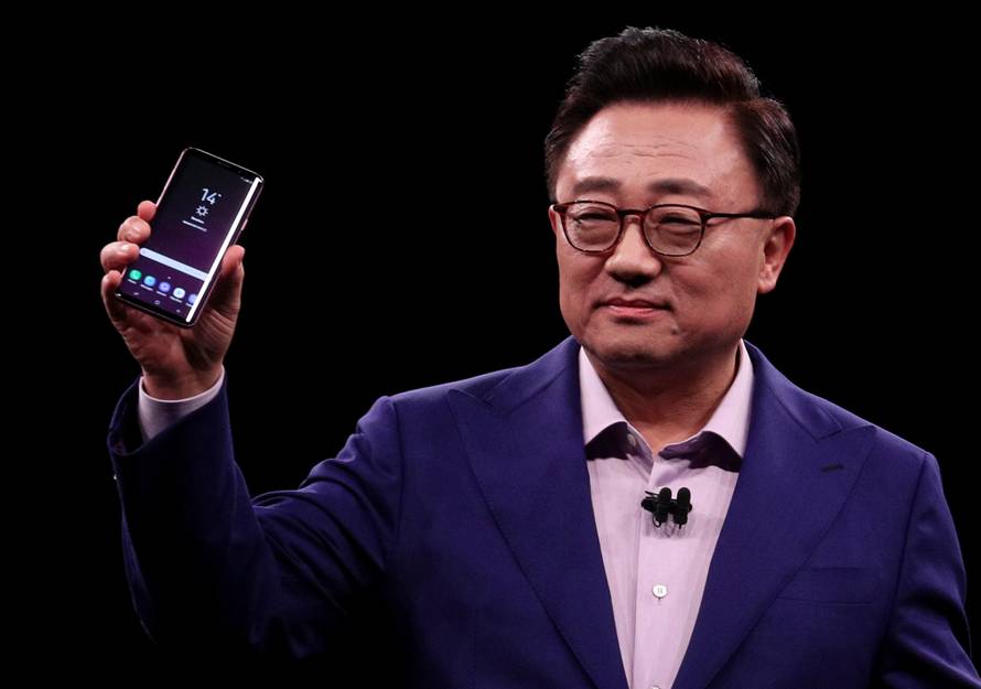 DJ Koh, Samsung's Mobile Communications Business president, holds up new S9Plus devicesduring presentation ceremony in Barcelona