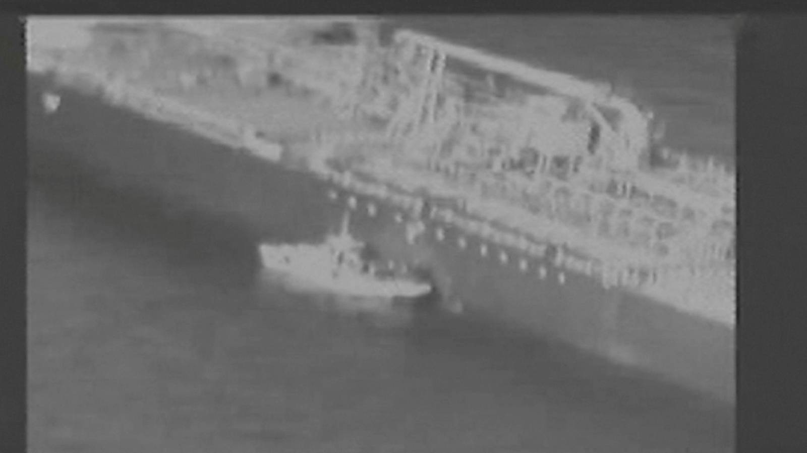 Still image taken from a U.S. military handout video purports to show Iran's Revolutionary Guard (IRGC) removing an unexploded limpet mine from the side of the Kokuka Courageous Tanker