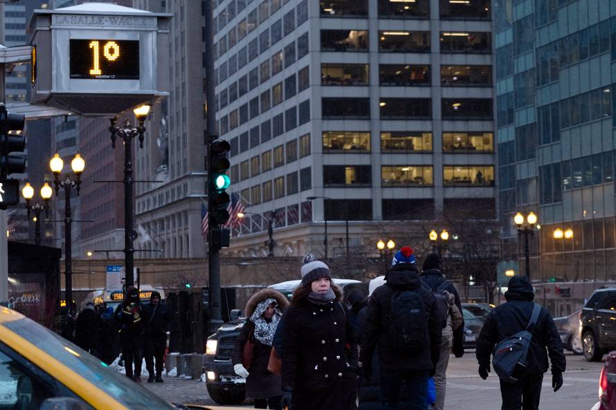 Pedestrians cross the street at rush hour as bitter cold phenomenon called the polar vortex has descended on much of the central and eastern United States