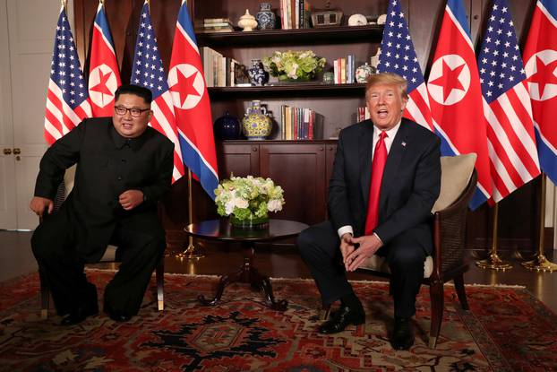 U.S. President Donald Trump sits next to North Korea