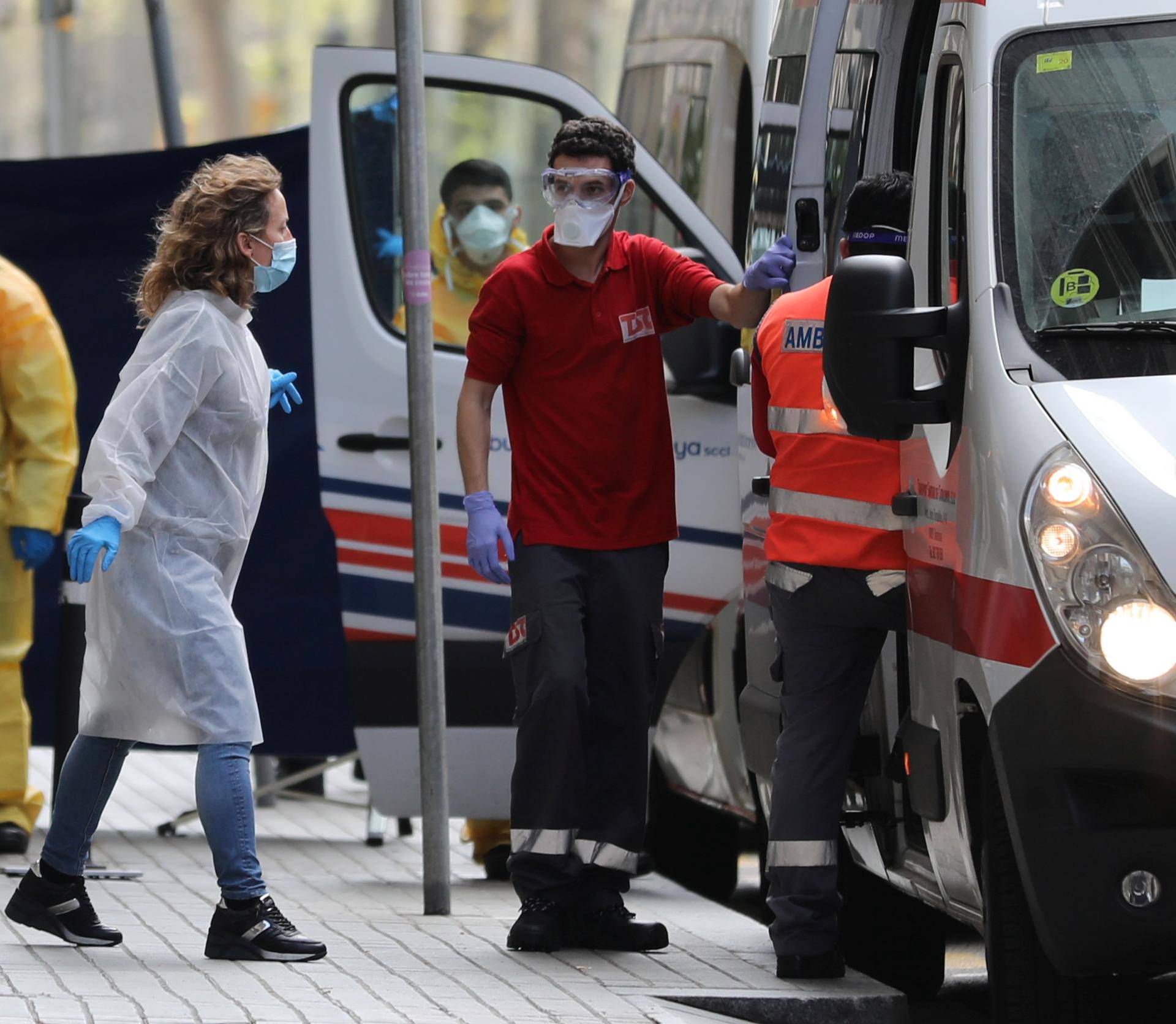 Medical workers are seen outside the Cotton House Hotel in Barcelona