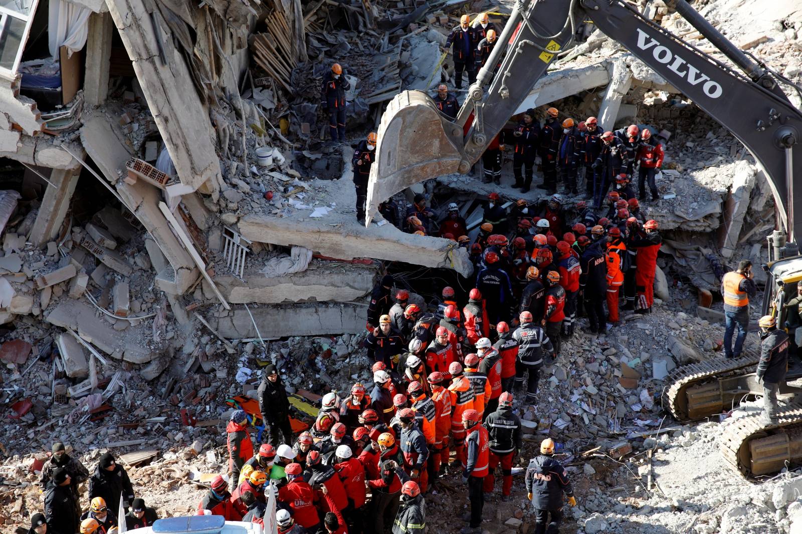 Rescue workers search the site of a collapsed building, after an earthquake in Elazig