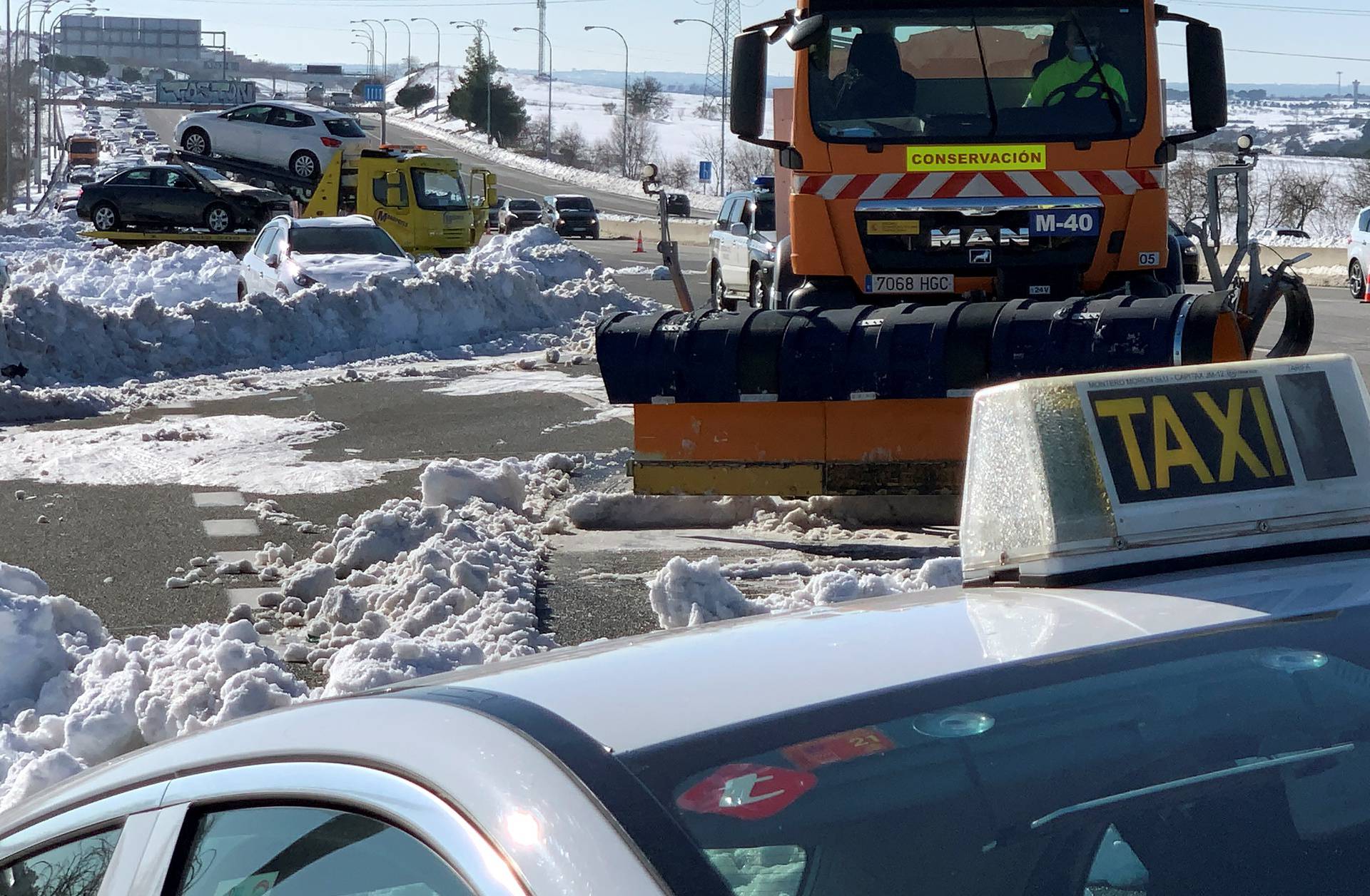 A taxi is towed on M-40 highway after heavy snowfall in Madrid