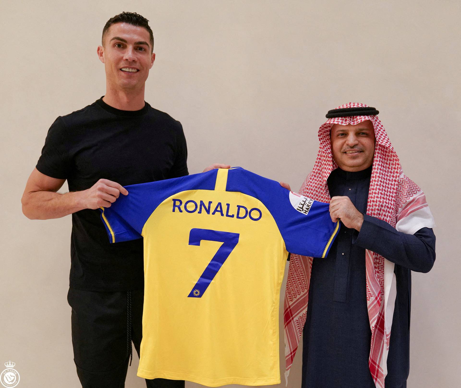 Portuguese soccer player Cristiano Ronaldo holds a shirt of the Saudi club Al-Nassr after signing the contract