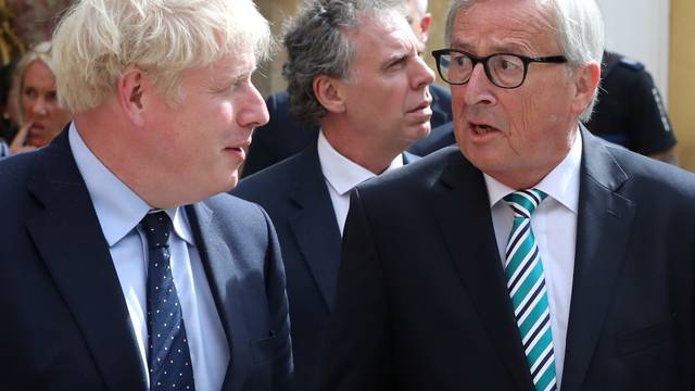 British Prime Minister Boris Johnson and European Commission President Jean-Claude Juncker talk as they leave after their meeting in Luxembourg