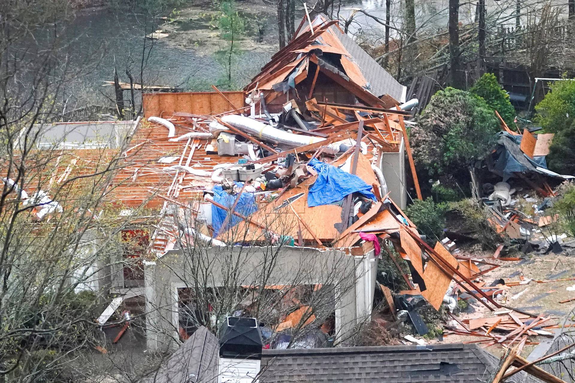 A house is left missing a roof after a tornado passed through the Eagle Point subdivision in Hoover