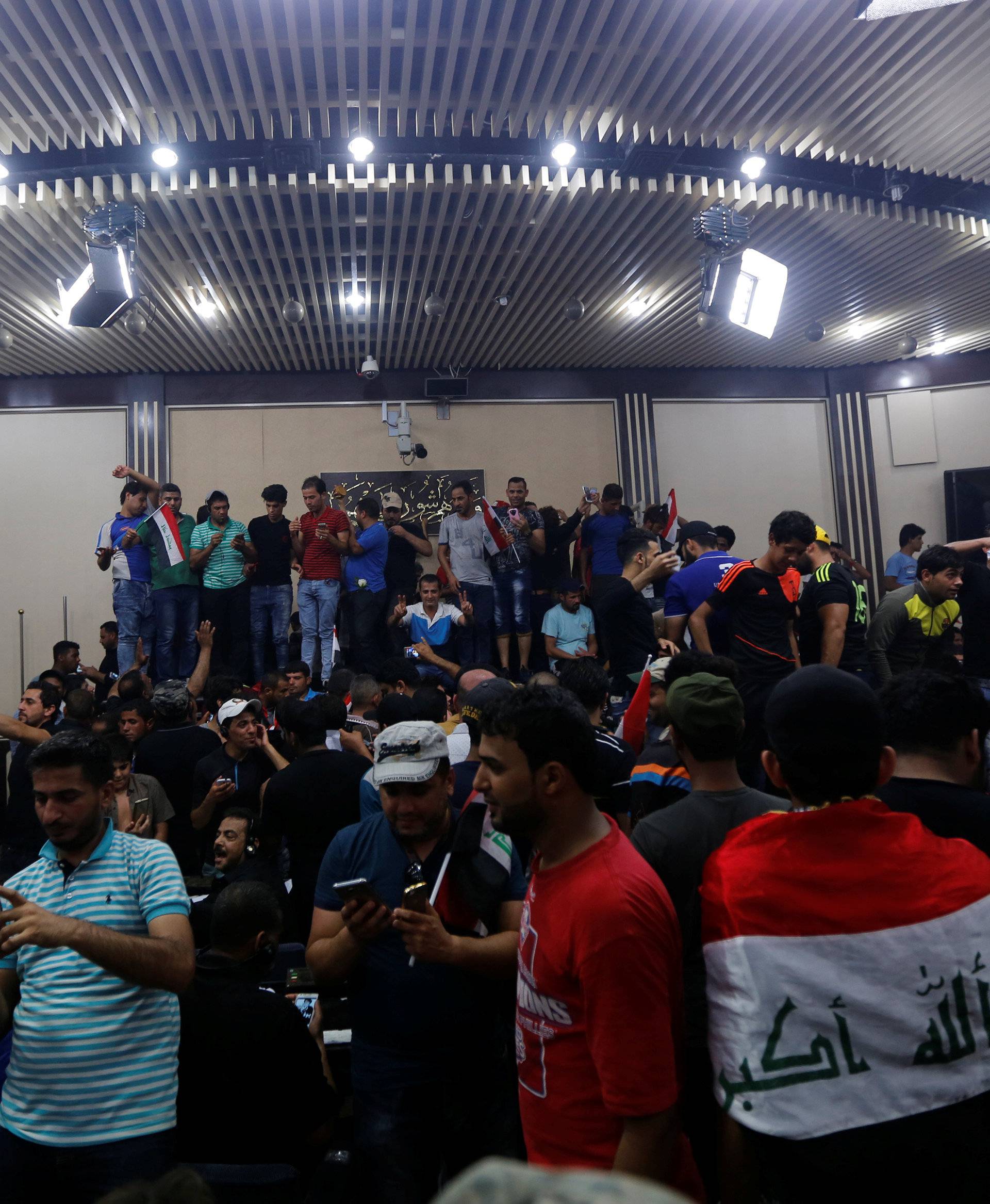 Followers of Iraq's Shi'ite cleric Moqtada al-Sadr are seen in the parliament building as they storm Baghdad's Green Zone after lawmakers failed to convene for a vote on overhauling the government, in Iraq