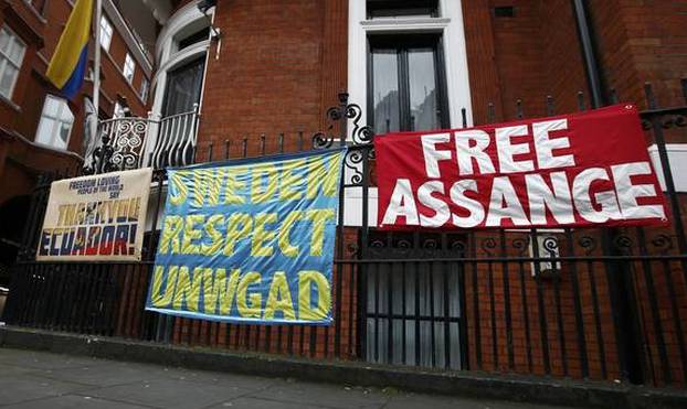 Posters and banners are attached to railings after prosecutor Ingrid Isgren from Sweden arrived at Ecuador
