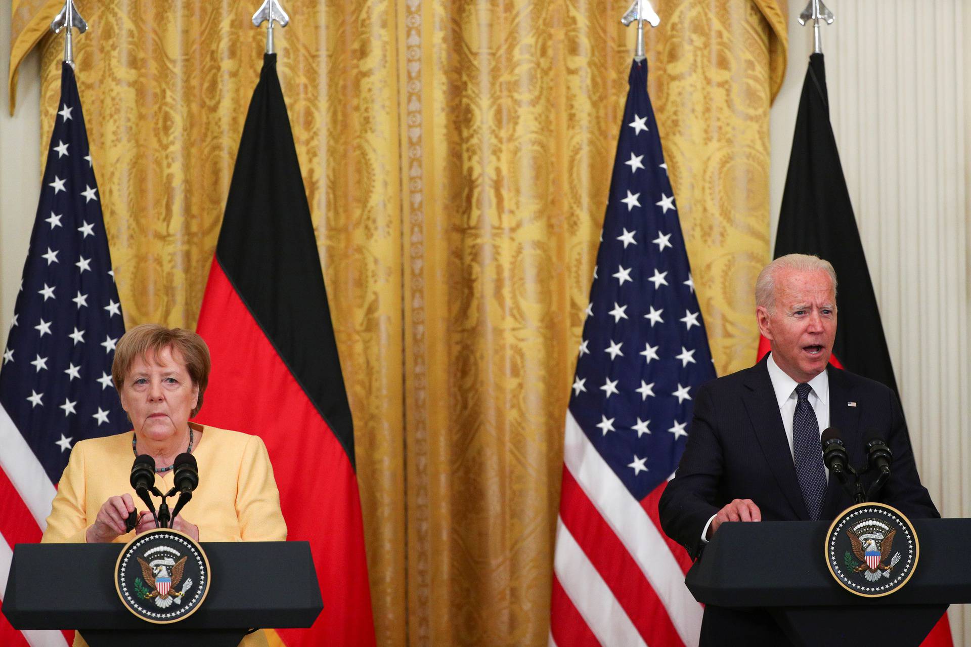 U.S. President Joe Biden and German Chancellor Angela Merkel attend a joint news conference in the East Room at the White House