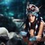 Futuristic indian woman portrait outdoors. blue wild forest on background