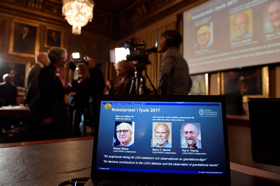 The names of Rainer Weiss, Barry C. Barish, Kip S. Thorne are displayed on the screen during the announcement of the winners of the Nobel Prize in Physics 2017, in Stockholm