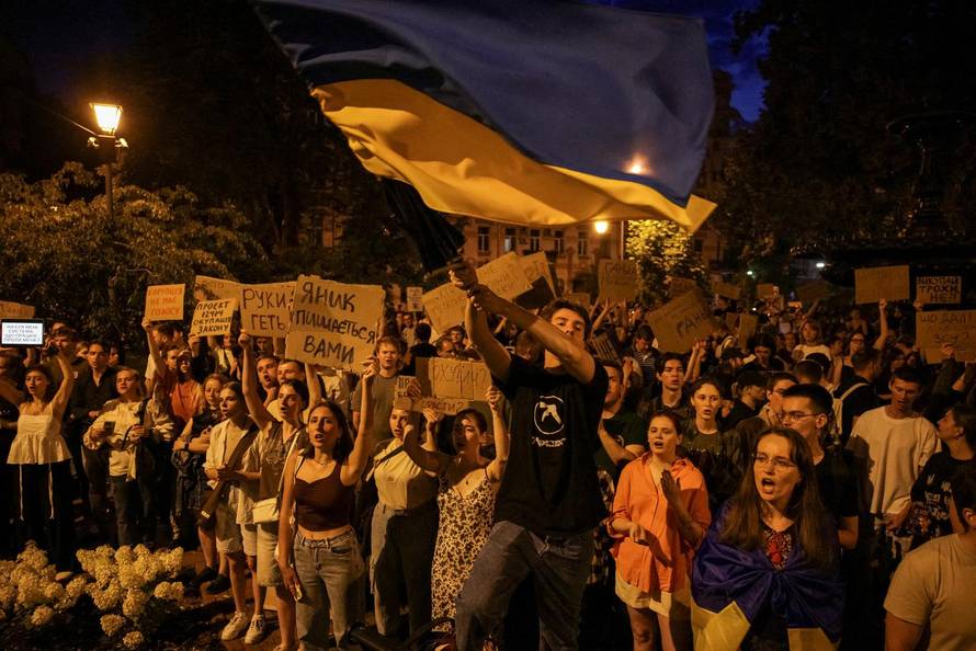 Ukrainians protest against a newly passed law, which curbs independence of anti-corruption institutions near the presidential office in Kyiv