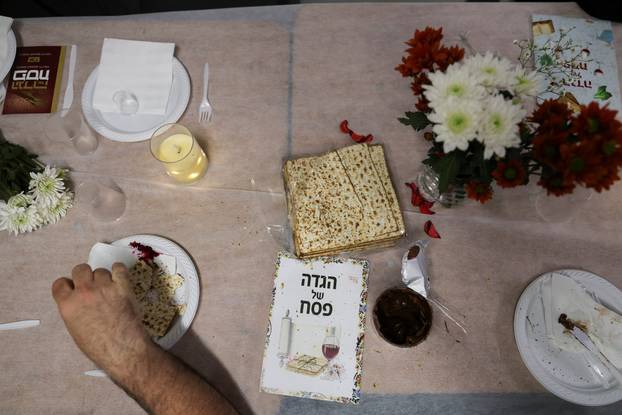 Israelis hold a Passover Seder in an underground parking garage used as a public bomb shelter, in Tel Aviv