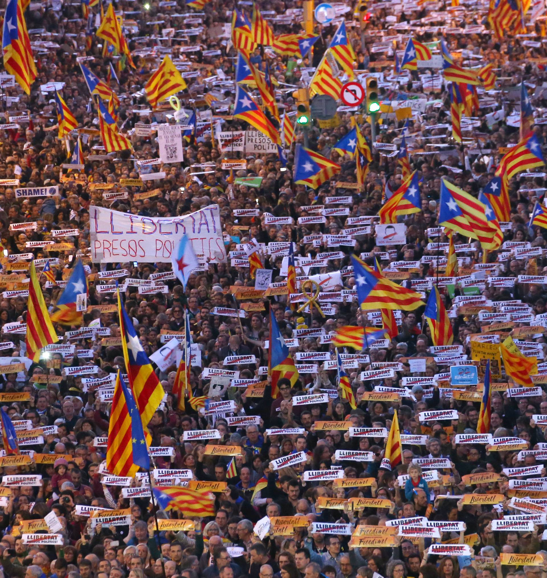 Protesters hold banners during a demonstration called by pro-independence associations asking for the release of jailed Catalan activists and leaders, in Barcelona