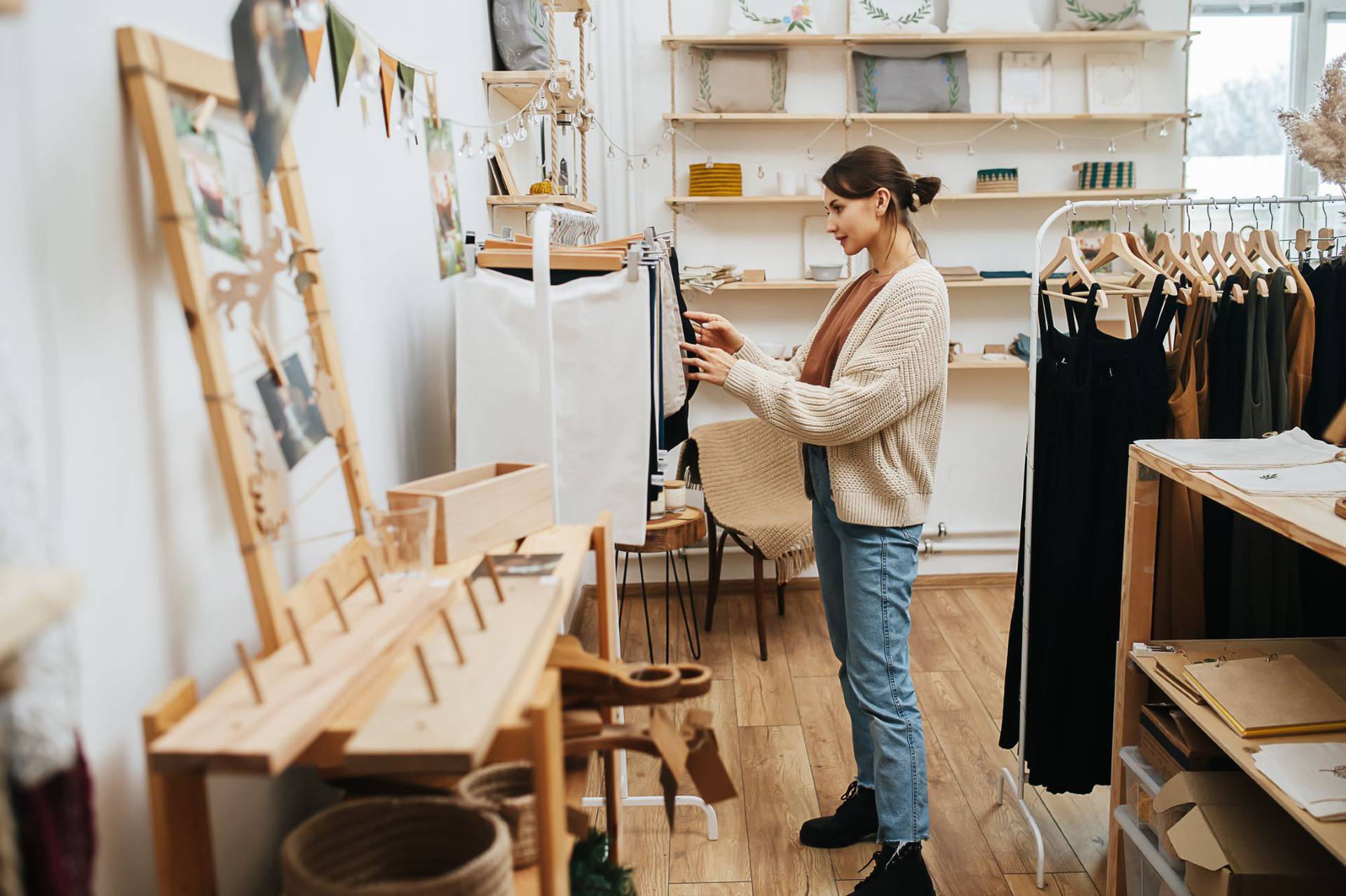 Curious,Woman,In,An,Ecological,Shop,Looking,Through,Fabric,Eco