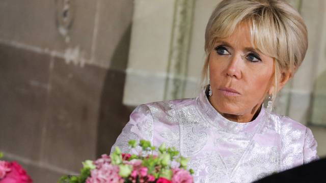 French President's wife Brigitte Macron listens to speeches at the start of an official state dinner with with Japan's Crown Prince Naruhito at the Chateau de Versailles castle