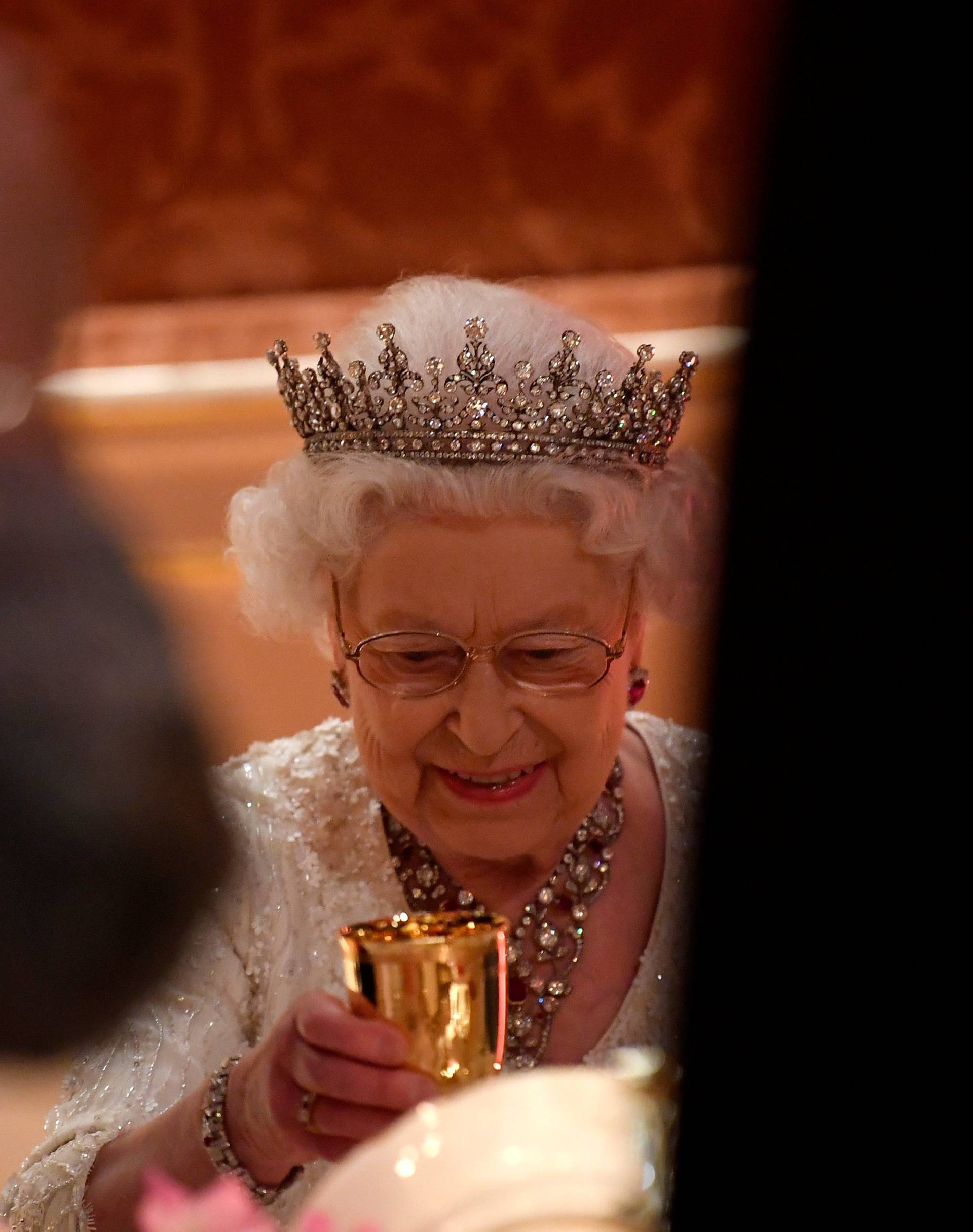 Britain's Queen Elizabeth raises her glass during speeches at The Queen's Dinner during the Commonwealth Heads of Government Meeting at Buckingham Palace in London, Britain